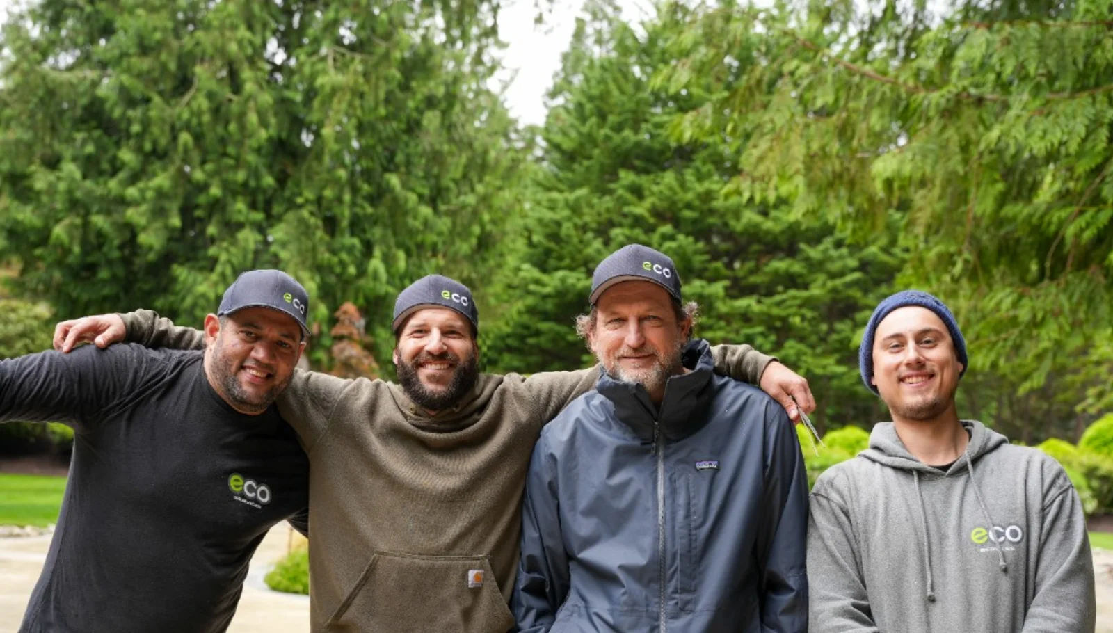 Four Eco technicians outdoors in branded gear