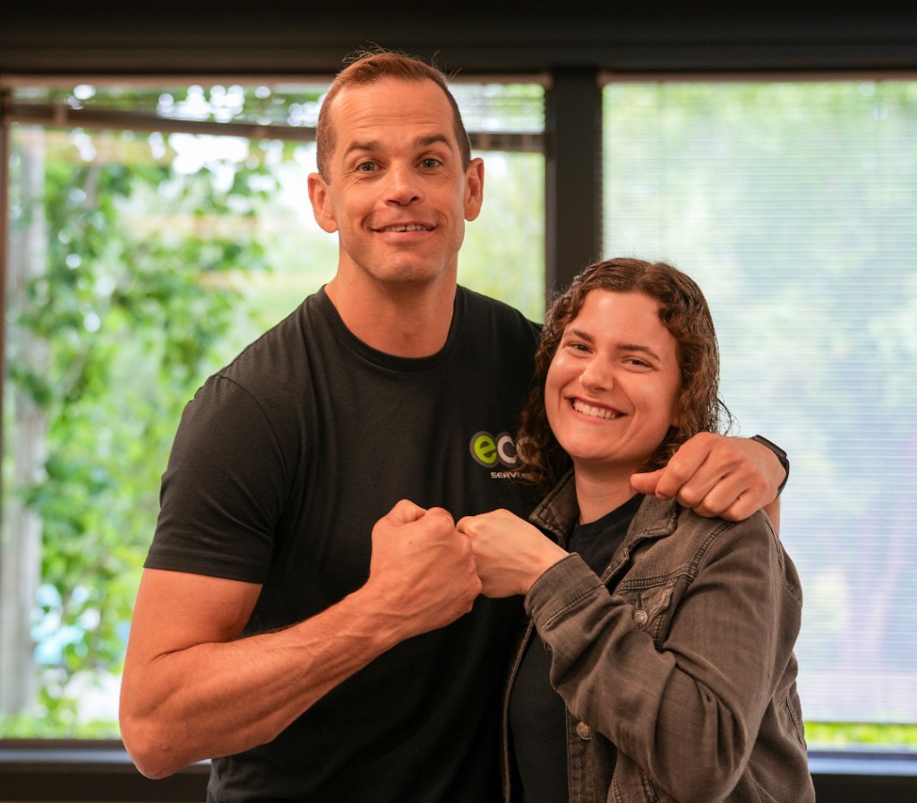 Two Eco team members sharing a fist bump at the office